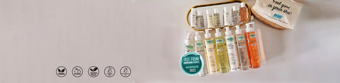 Set of skincare products with a small bag on a light gray background