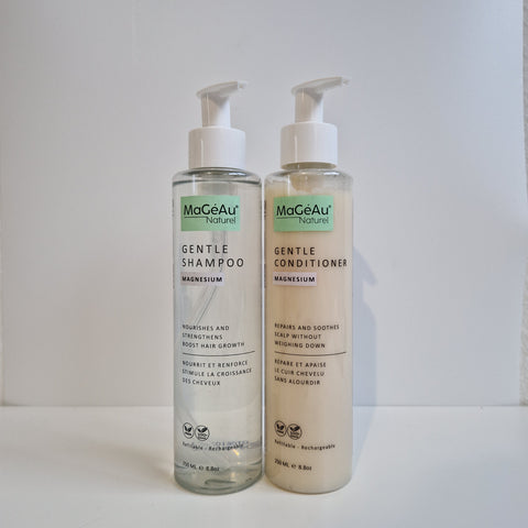 Two bottles of MaGeAu Magnesium Gentle Shampoo and Gentle Conditioner on a light gray background