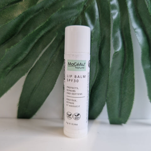 Mageau Magnesium Lip balm SPF 30 tube with green leaves in the background