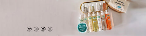 Set of skincare products with a small bag on a light gray background